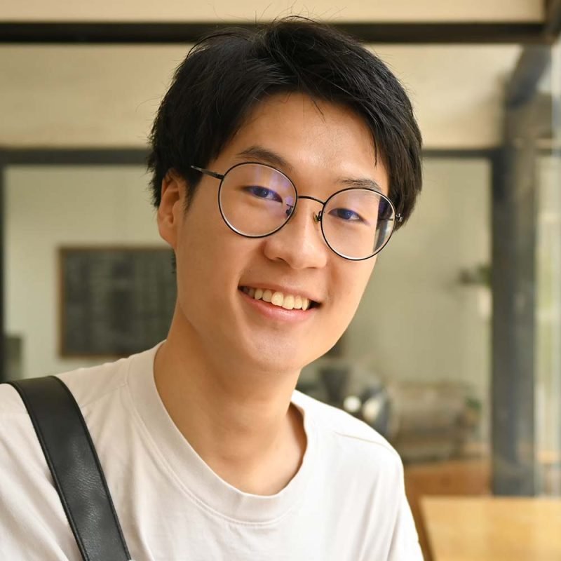 asian-male-university-student-in-glasses-holding-b-5TFS3Y8-800x800