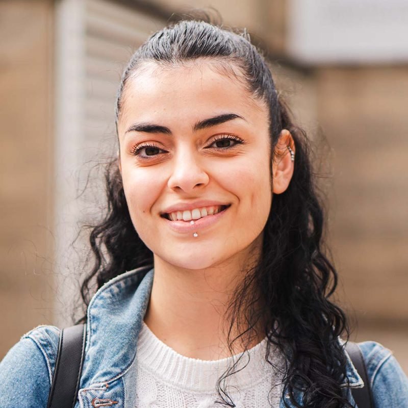 pretty-hispanic-female-student-smiling-and-looking-CFSPSYT-800x800
